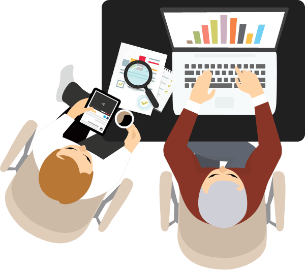 Two people at desk with laptop tablet and documents