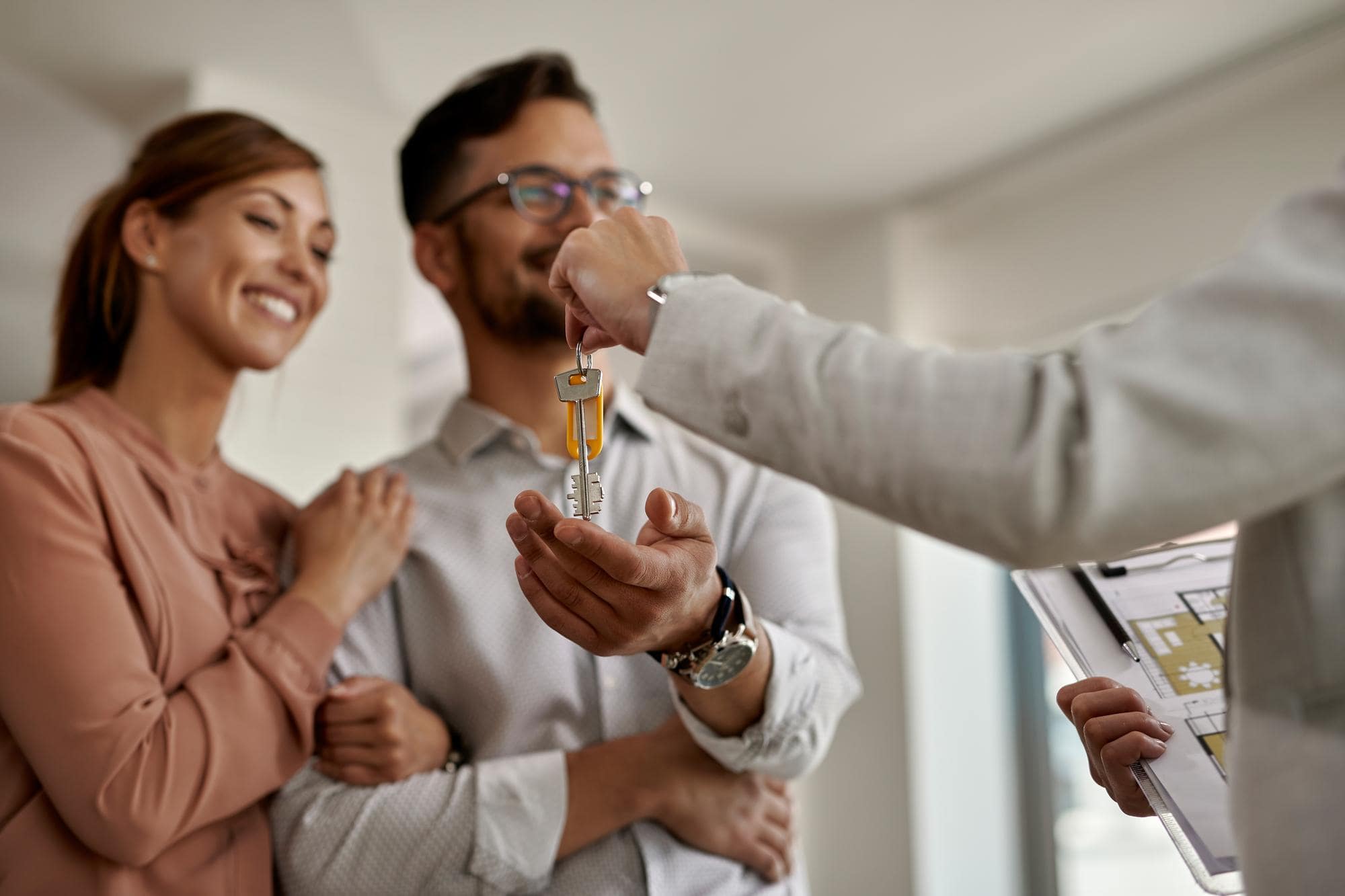 Couple getting house keys from a real estate agent