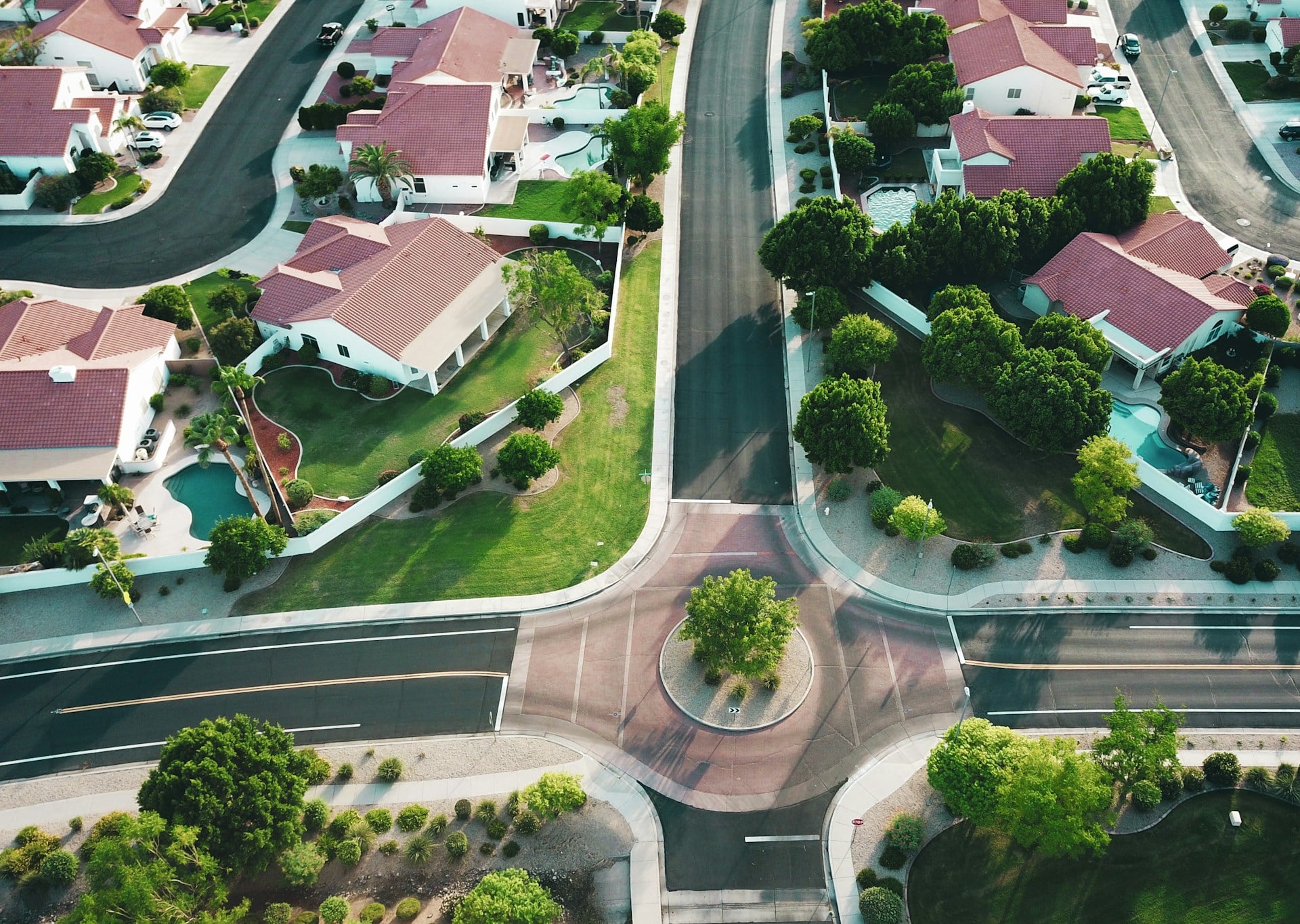 Aerial view of California real estate houses with red roofs and green lawns