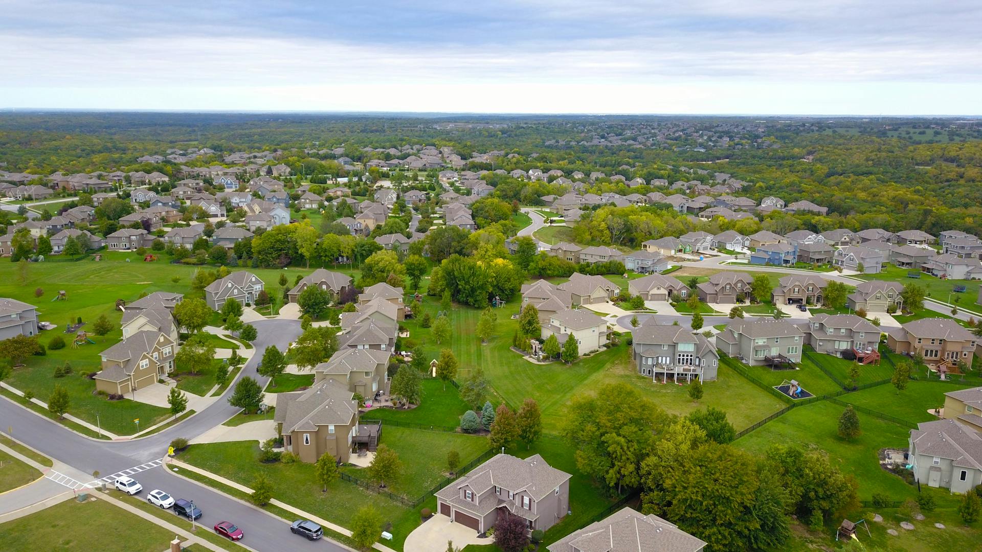 Aerial view of California real estate houses with trees and green spaces