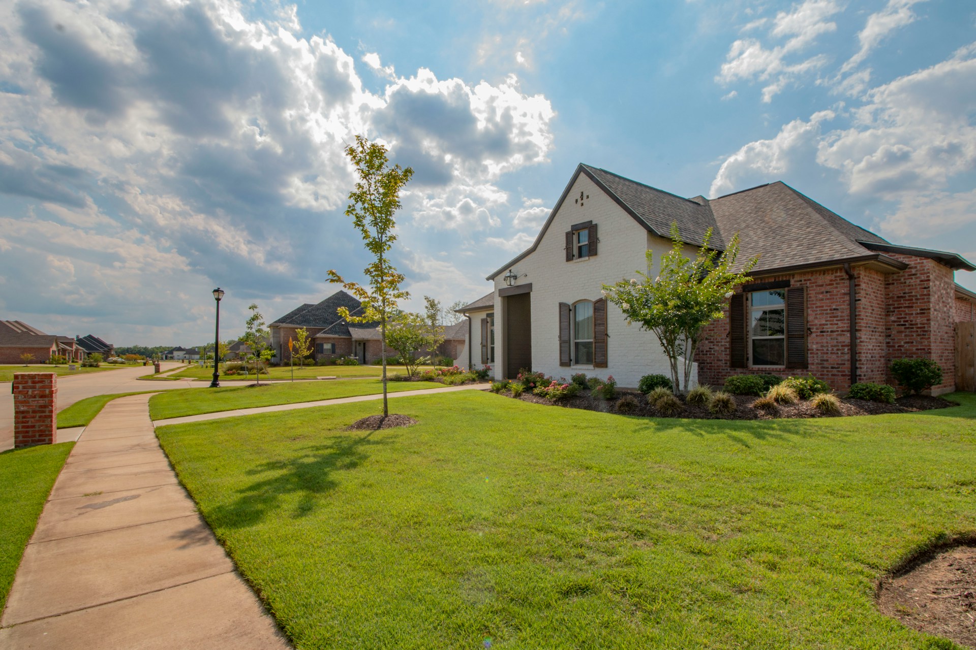 Brick houses with green lawns in a quiet neighborhood California real estate