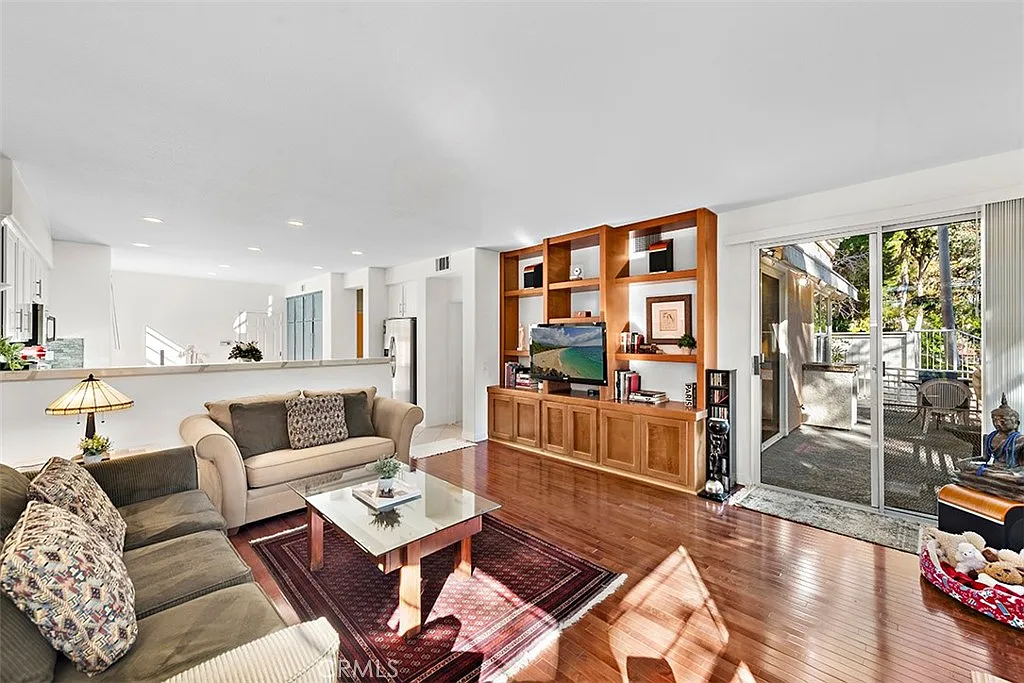 Living room with sofa coffee table TV and outdoor view