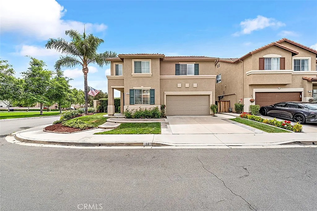 Two story California real estate house with lawn palm trees and driveway