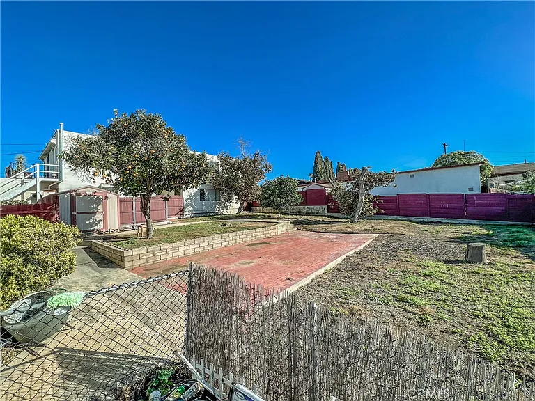 Backyard with brick patio grass and trees