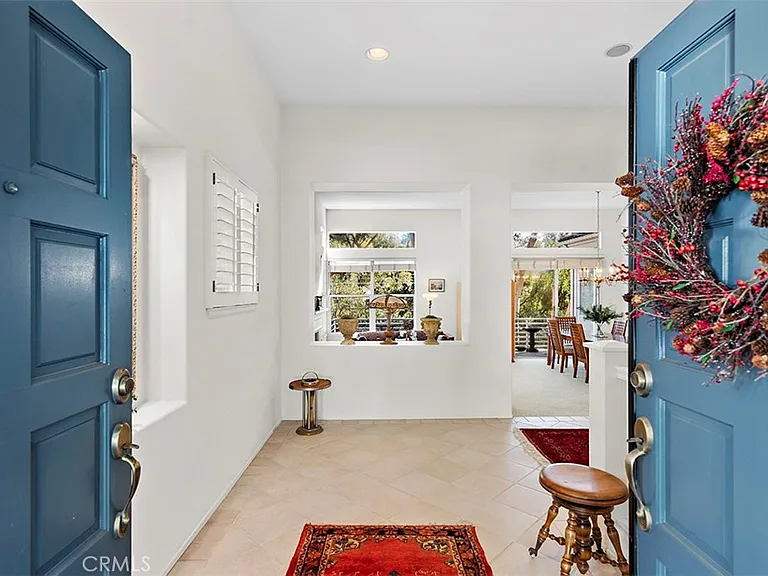 Entry of California real estate house with blue doors table and rug