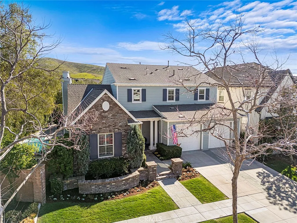 Two story California real estate house with brick siding porch and yard