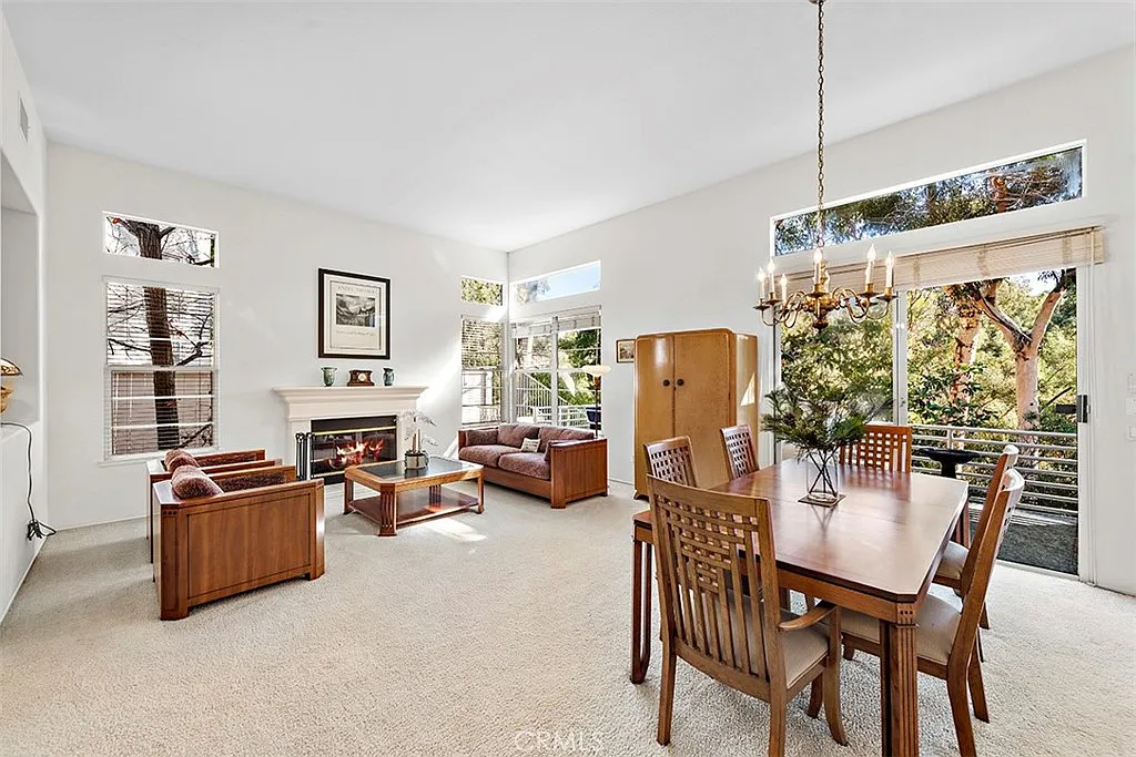 Living room with fireplace wooden furniture and dining table