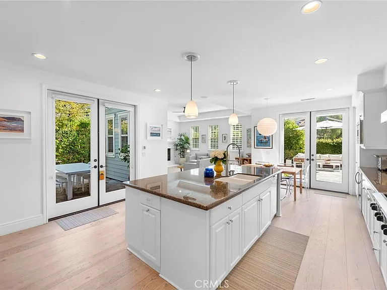 Kitchen with island white cabinets and outdoor patio view