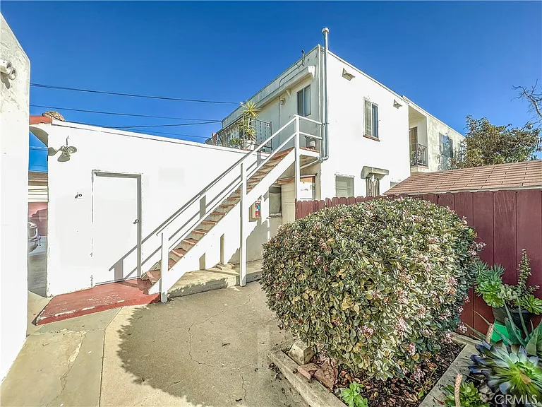 White building with stairs and green plants