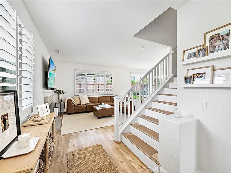 Living room with tan sofa TV and staircase