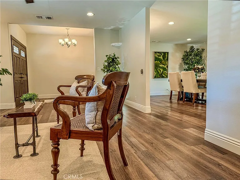 Interior with wooden floors chairs dining area and plants