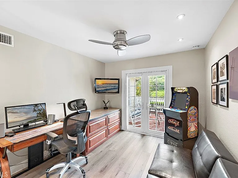 Home office with desk computer TV and outdoor view