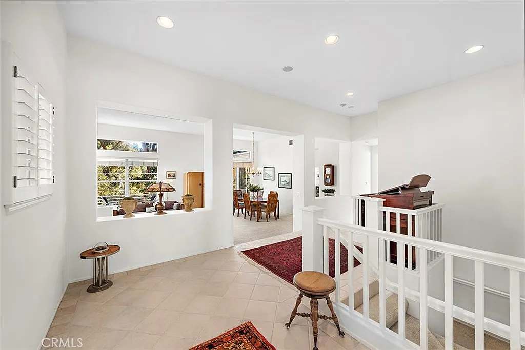 Hallway with staircase table and rug