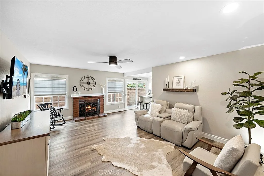 Living room with beige sofa fireplace and TV