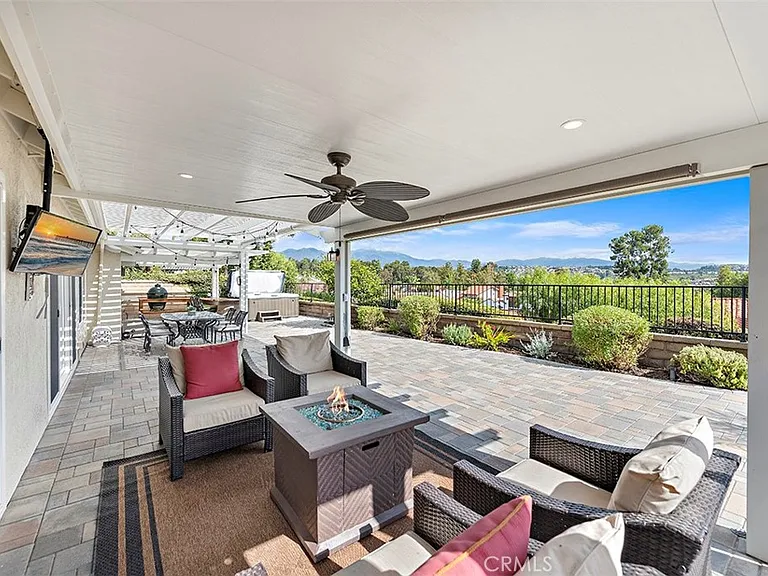 Outdoor patio with seating fire pit and greenery