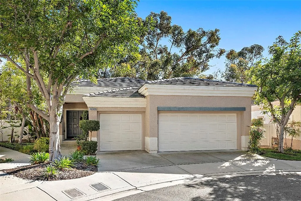 Single story California real estate house with double garage and trees