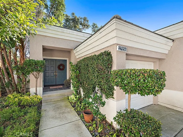 Entrance of California real estate house with blue door and plants