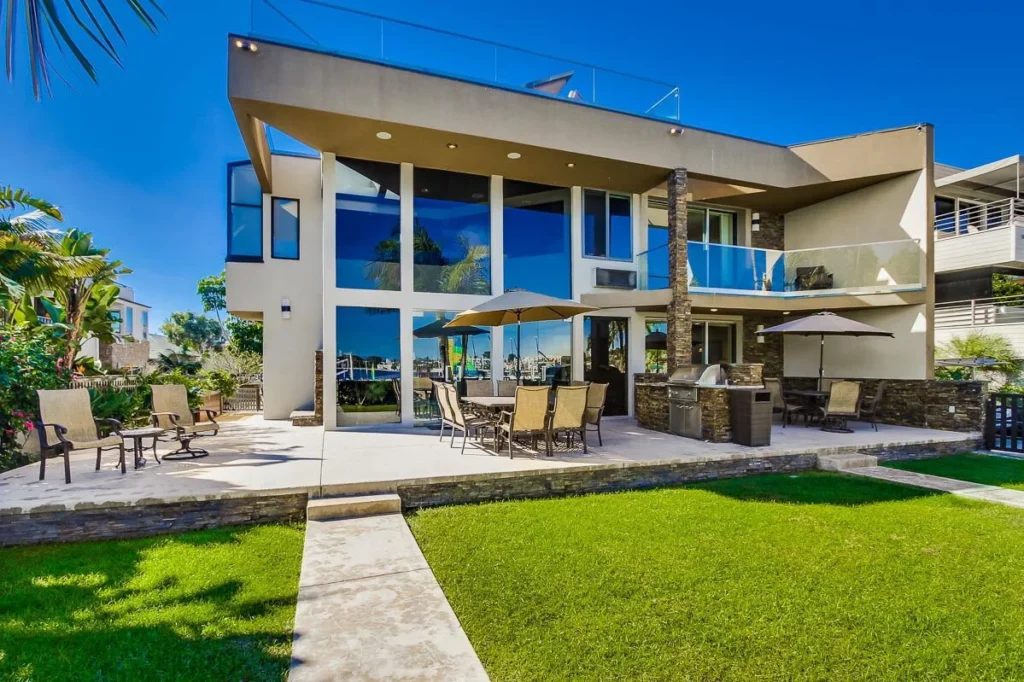 California real estate house with large windows patio and lawn