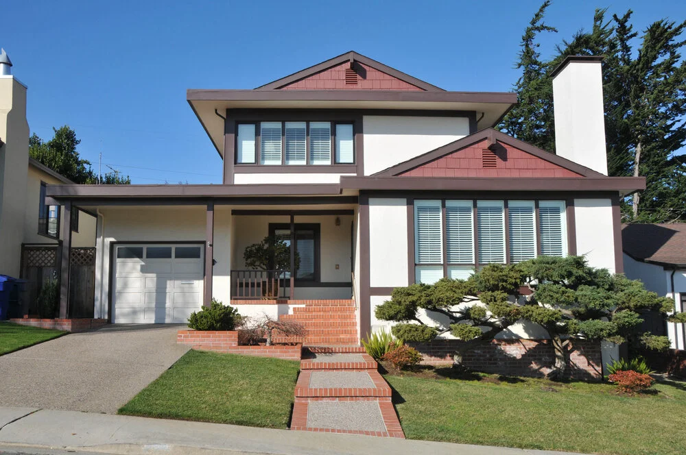Two story California real estate house with porch windows driveway and lawn