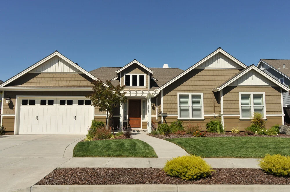 Two story California real estate house with tiled roof windows and lawn