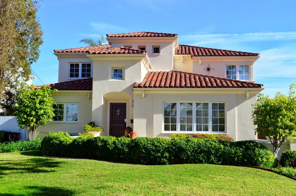 Luxury two story California real estate house with red tile roof windows and lawn